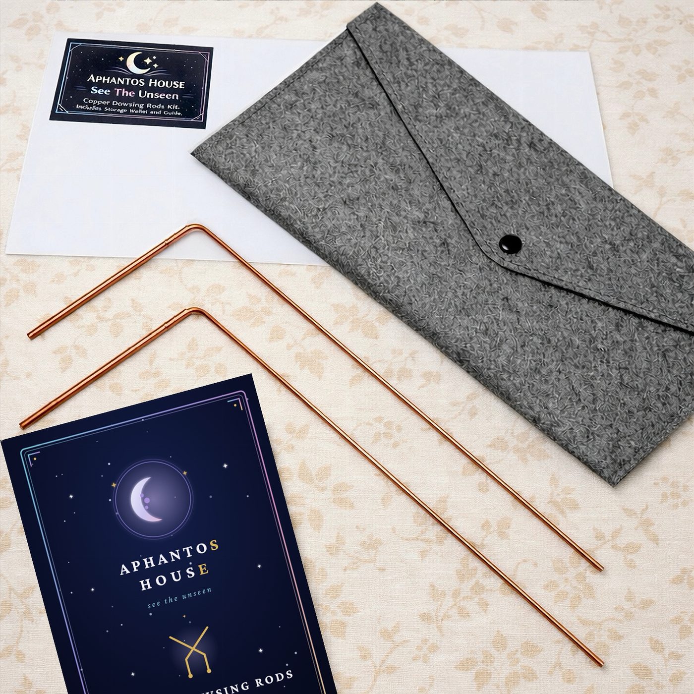 The complete kit: two copper dowsing rods, grey felt wallet, printed guide and brand card